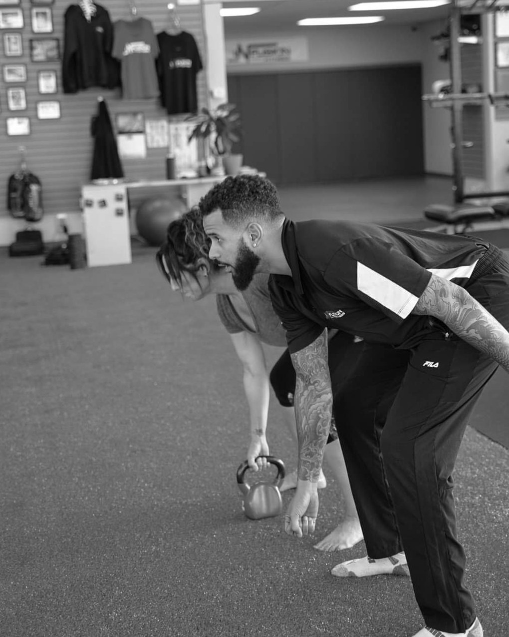 Cassidy coaches a client through the bottom of a kettlebell swing