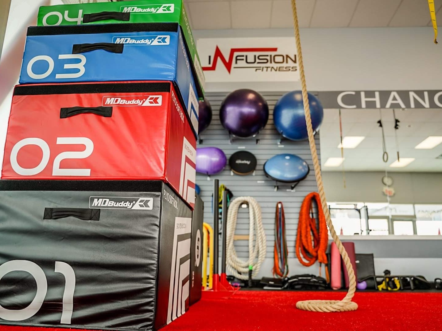 Plyo boxes, ropes and stability balls under the Infusion Fitness sign in the studio